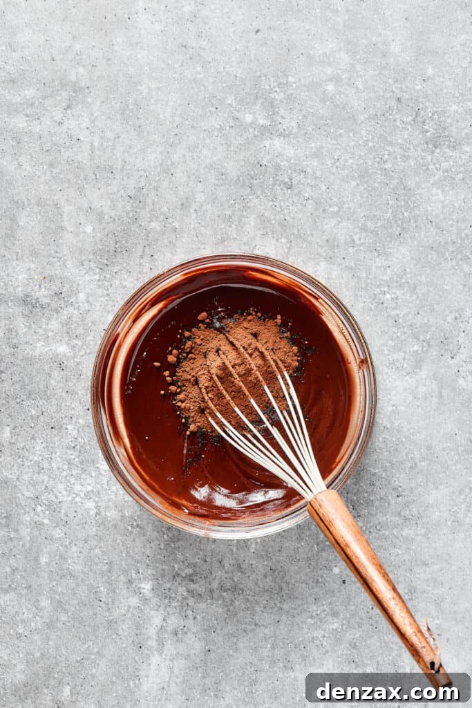 Marbled Chocolate Cheesecake Brownies 3 Whisking dark cocoa powder into the rich brownie batter, adding depth of flavor.
