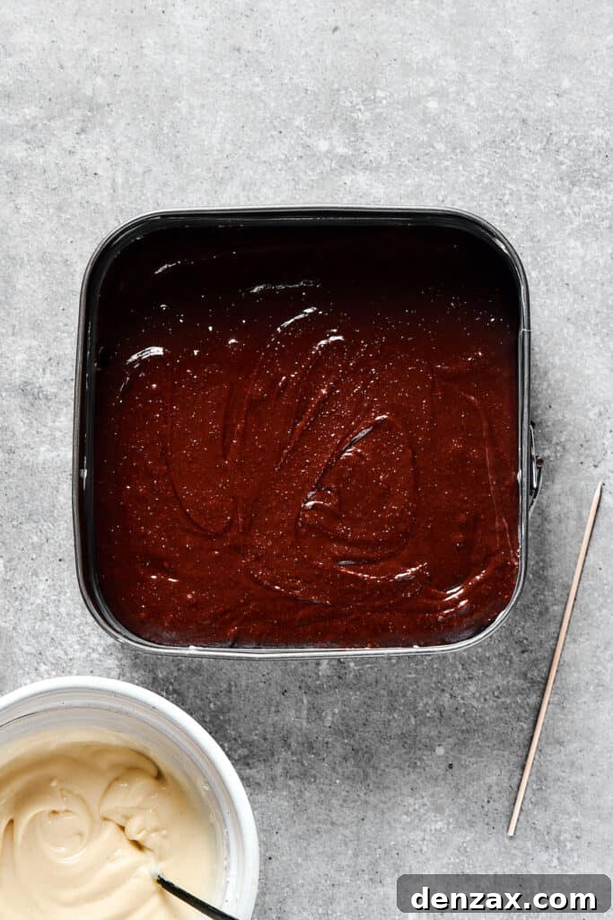 Marbled Chocolate Cheesecake Brownies 7 A pan filled with smooth, dark brownie batter, evenly spread and awaiting the cream cheese swirl.