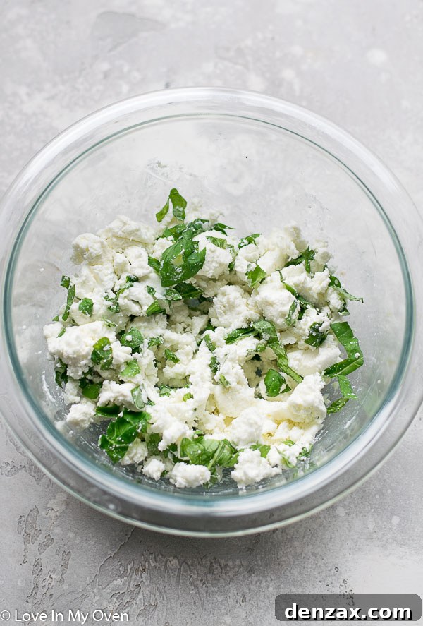 Close-up of goat cheese and basil mixture spread on grilled crostini