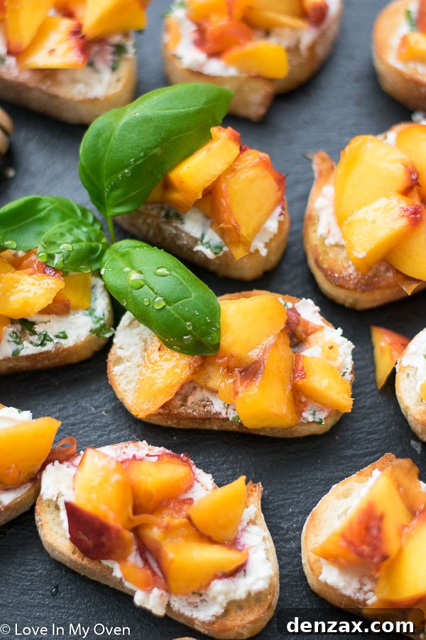 Two grilled peach crostini served on a small plate