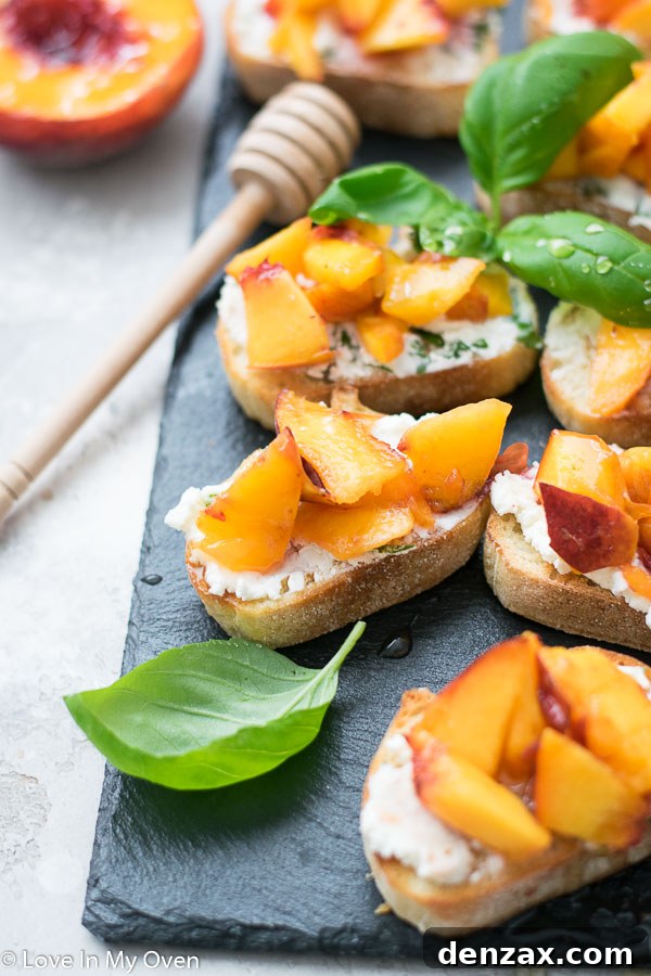 Several grilled peach crostini arranged aesthetically on a white plate
