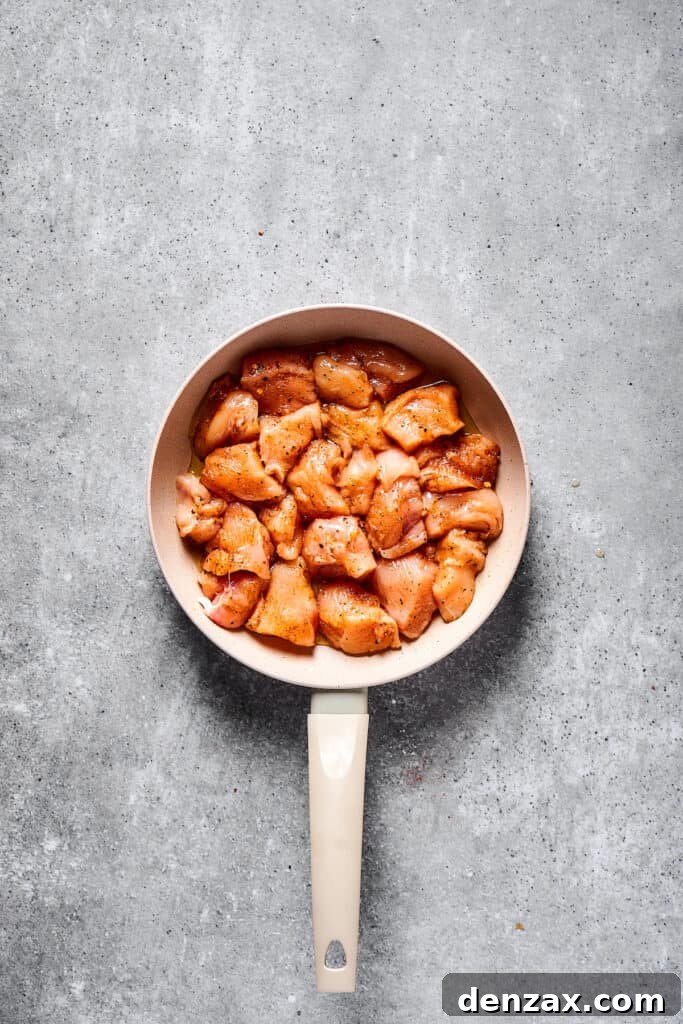 This Chicken Fajita Pasta, prepared with tender veggies and juicy chicken, makes the perfect dinner for family night or a casual get-together with friends. Raw chicken in a skillet.