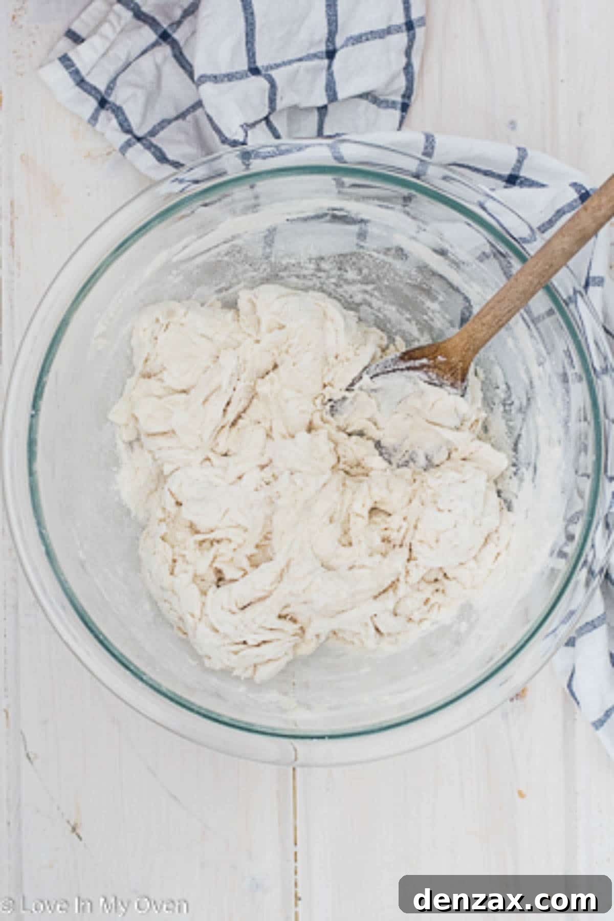 The shaggy, unkneaded dough in a mixing bowl, just combined with water, flour, yeast, and salt.