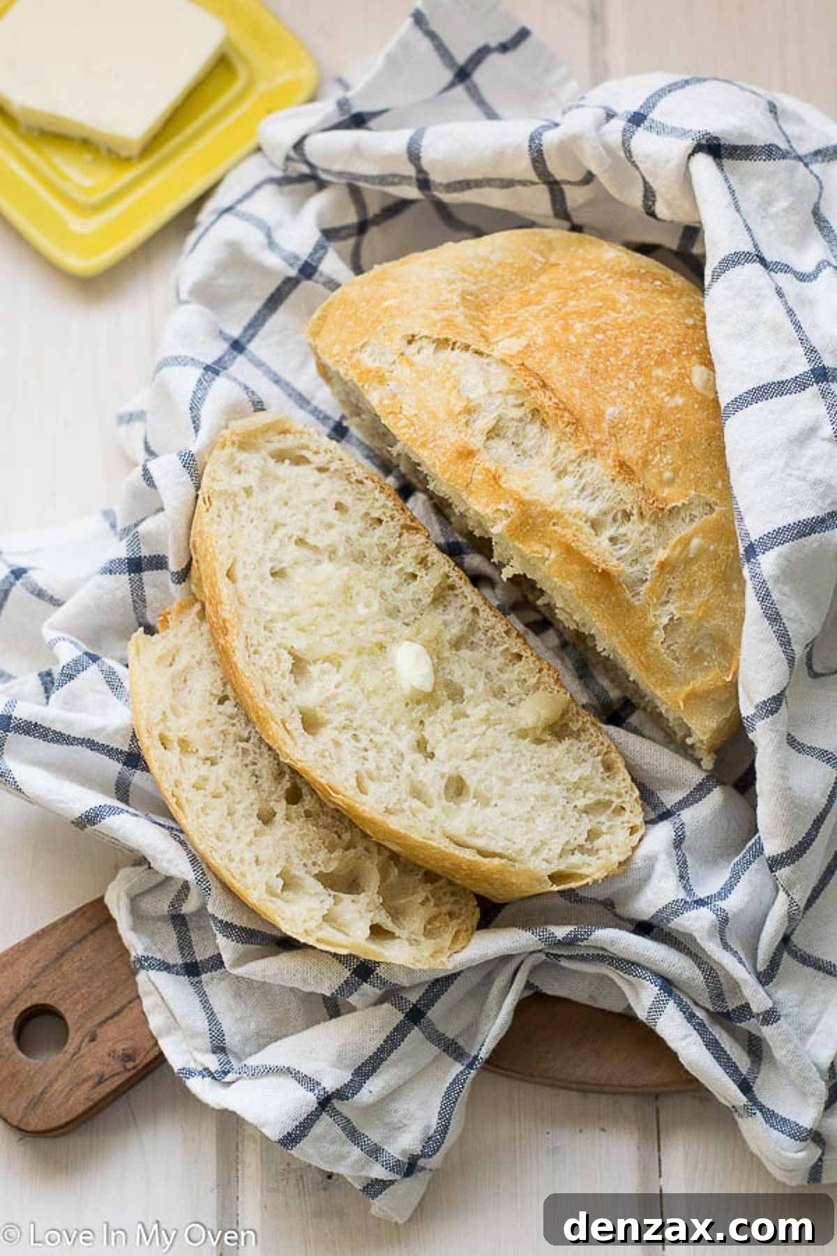 Two loaves of 3-ingredient bread, one whole and one sliced, showcasing the rustic appeal.
