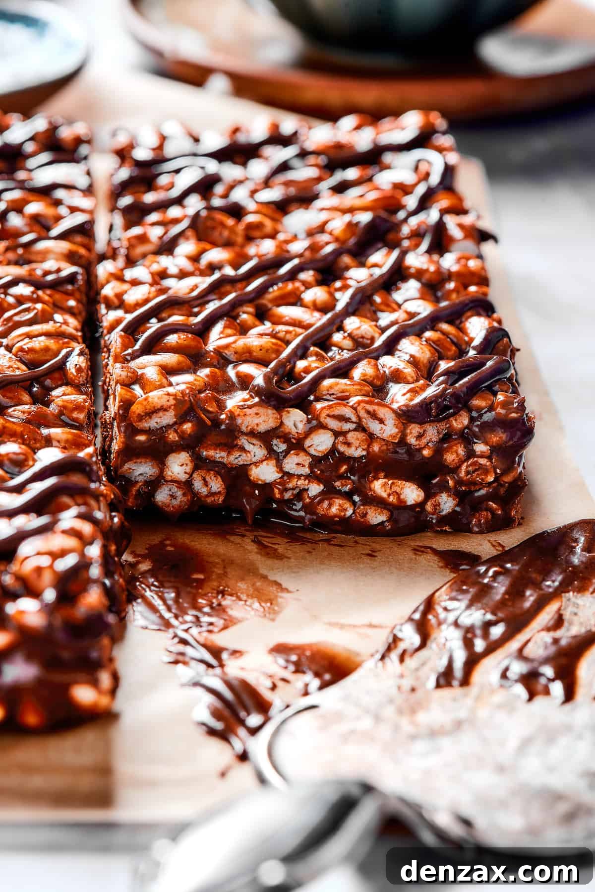 A close-up shot of a single chocolate cereal bar square, showcasing its layered texture with a rich chocolate and marshmallow topping, promising a delightful sensory experience.
