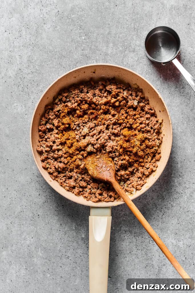 Taco meat cooked in a skillet.