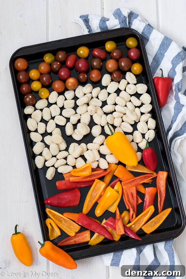 Ingredients for crispy sheet pan gnocchi on a baking sheet before cooking