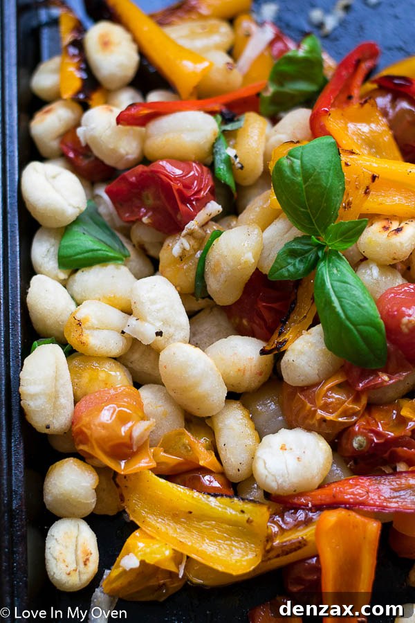 Crispy Sheet Pan Gnocchi with roasted tomatoes, peppers, and gnocchi in a bowl