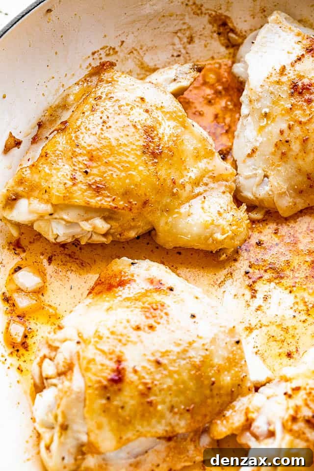 frying chicken thighs in pan