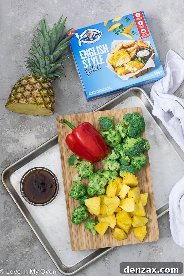 diced pineapple, bell peppers, and broccoli on a sheet pan
