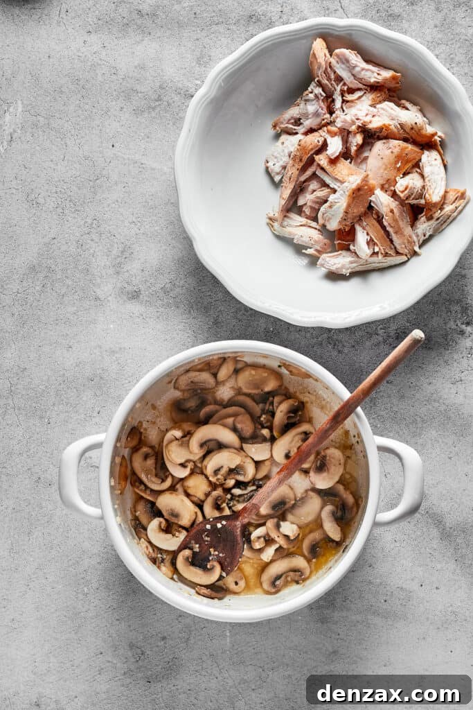 Sliced mushrooms being sautéed in a pan until tender and lightly browned.