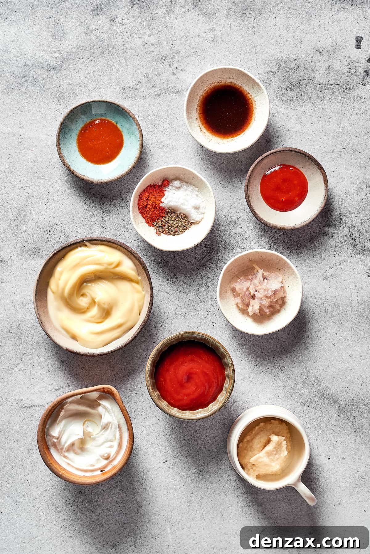 An assortment of Russian dressing ingredients, meticulously measured and arranged in small, elegant dishes, ready for mixing.