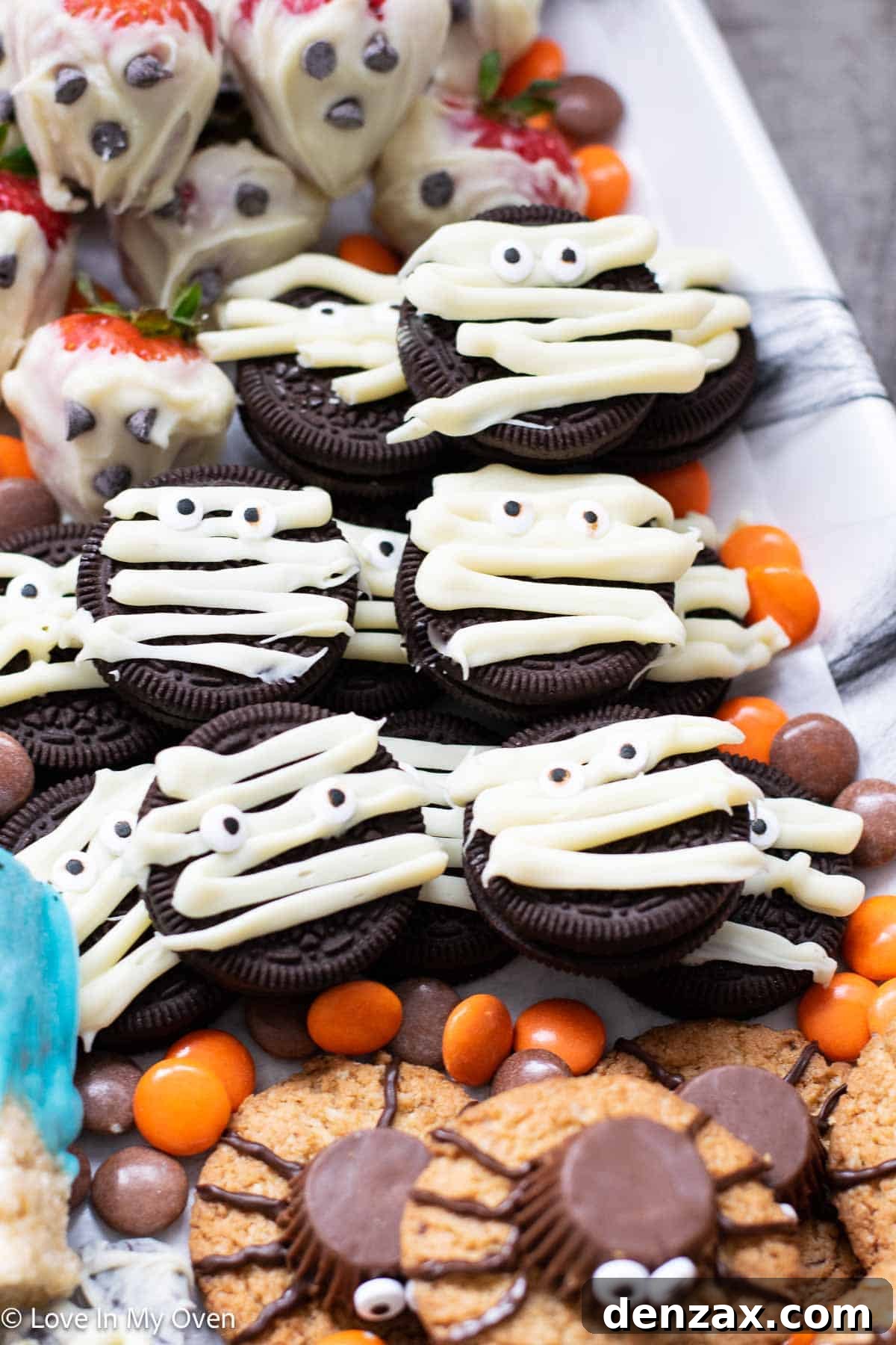 Spooky Sweet Creations for Kids 13 Oreo Mummy Cookies with white chocolate drizzles and candy eyeballs for Halloween.