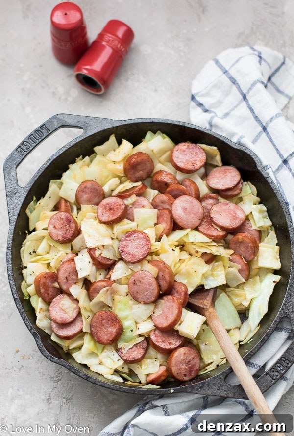 Sausage and Cabbage Skillet served on a plate with fresh herbs