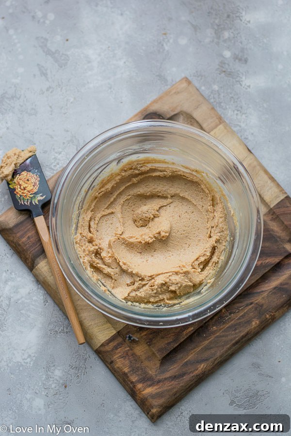 Healthier Chocolate Peanut Butter Sheet Cake with peanut butter frosting being applied