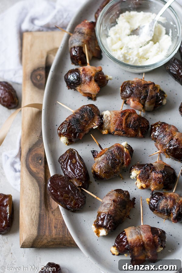 Close-up of crispy bacon-wrapped stuffed dates on a baking sheet, showcasing their golden-brown perfection.