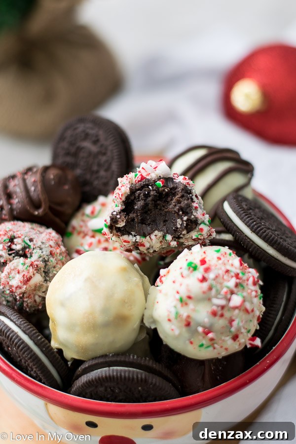A trio of perfectly coated 3-ingredient Oreo truffles on a rustic wooden board