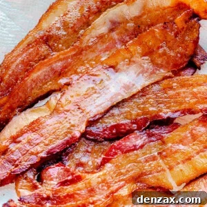 Oven baked bacon on a paper towel.
