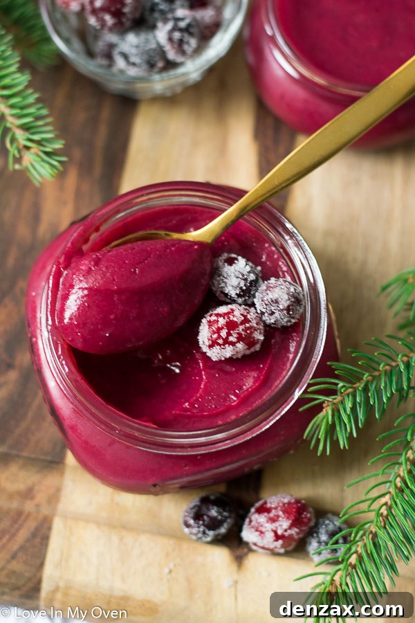 Vibrant Cranberry Curd 6 Close-up of cranberry curd in a jar with festive decoration.