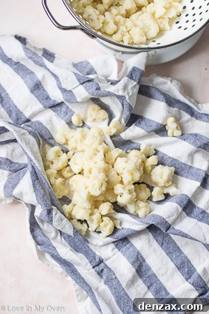 Cauliflower being squeezed in a dishtowel