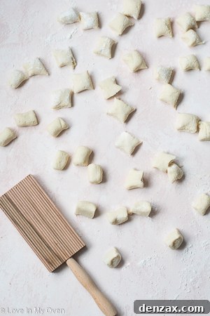 Slicing gnocchi ropes into individual pieces