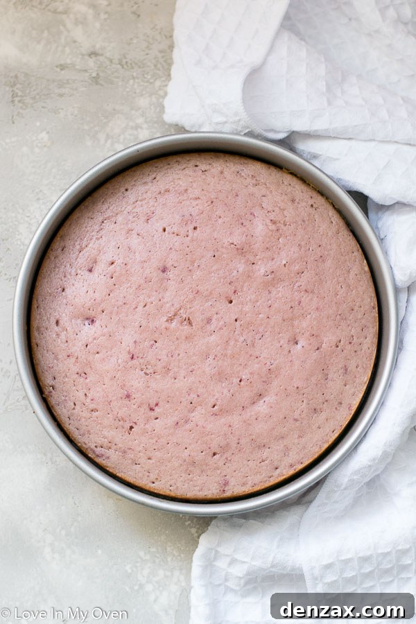 Cooled strawberry cake being crumbled for cake pops
