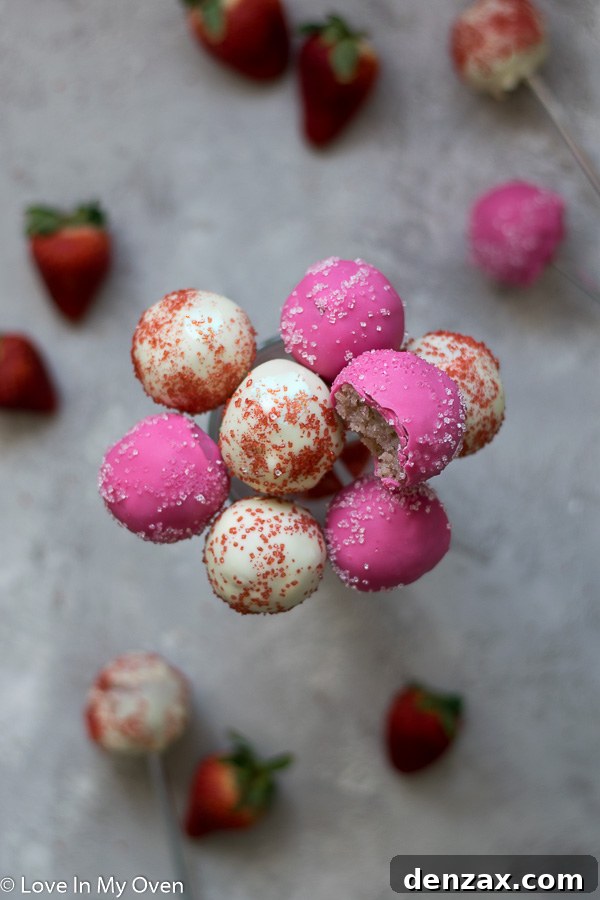 Close-up of a finished strawberry cake pop with sprinkles