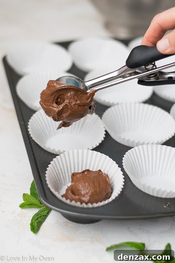 Unbaked mint chocolate cupcake batter in paper liners, ready for the oven