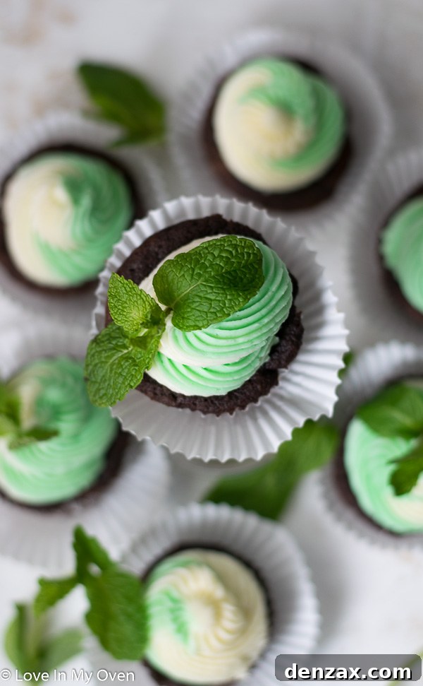 Seven beautifully decorated Mint Chocolate Cupcakes on a rustic wooden board, ready to serve