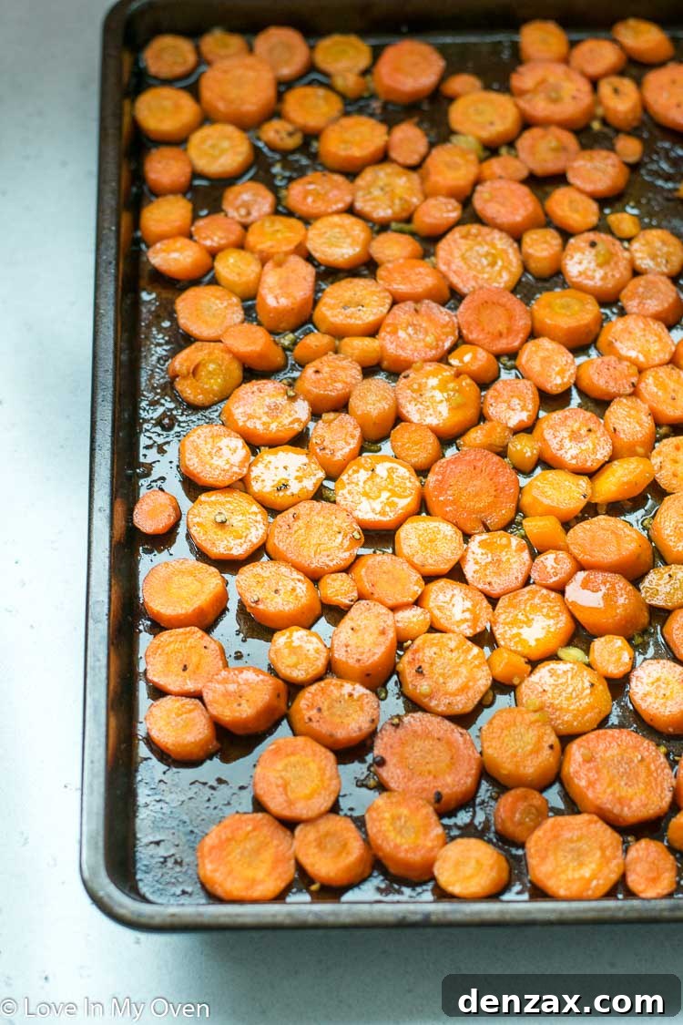 Close-up of roasted carrots on a baking sheet with caramelized edges