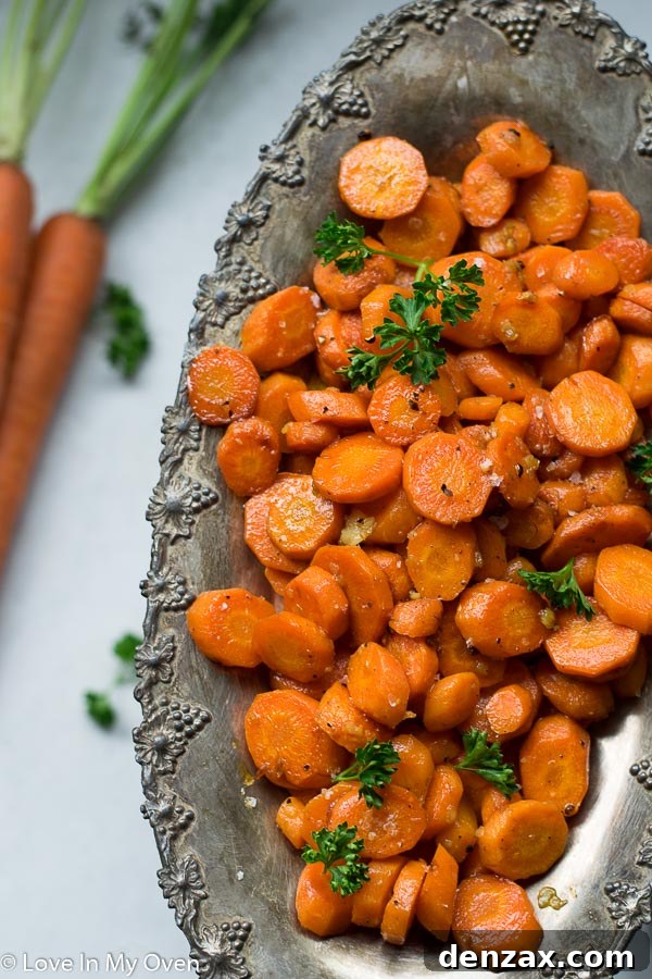 Serving dish filled with golden-brown Garlic Butter Roasted Carrots