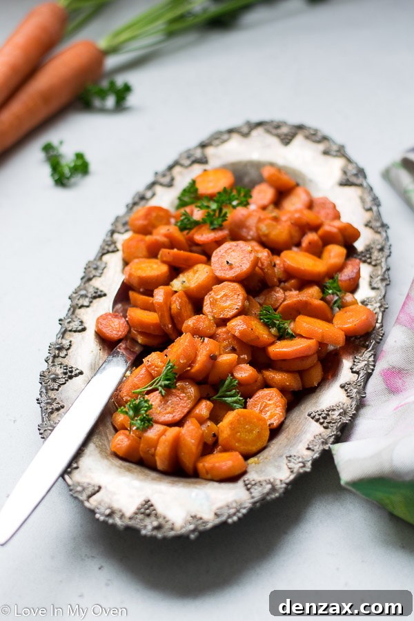 Stacked Garlic Butter Roasted Carrots on a small plate, ready to eat