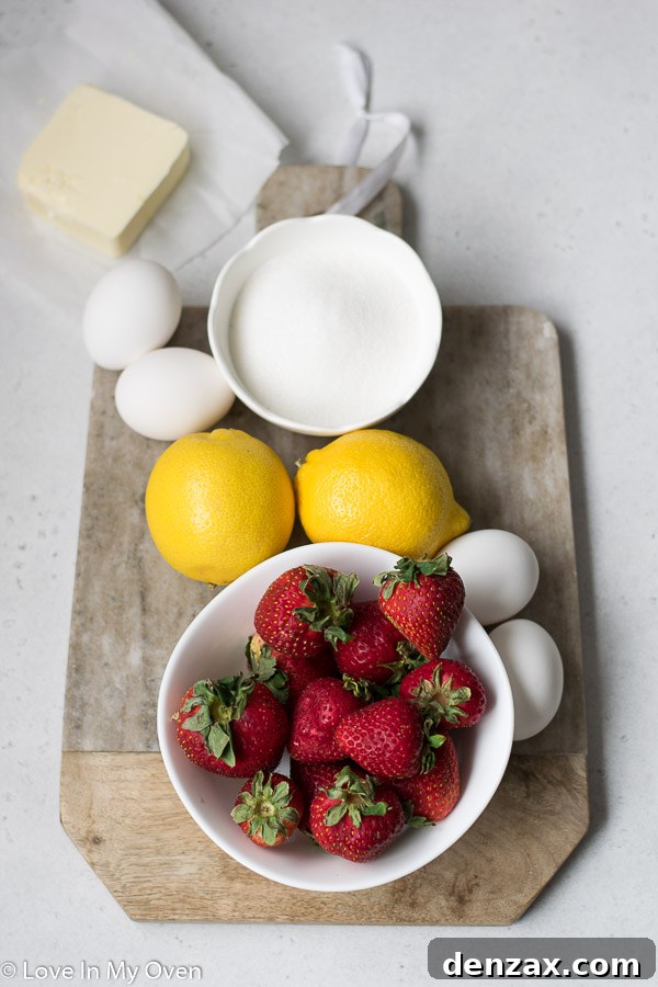 Ingredients for homemade strawberry lemon curd displayed on a kitchen counter, including fresh strawberries, whole lemons, granulated sugar, egg yolks in a bowl, and cubed butter.