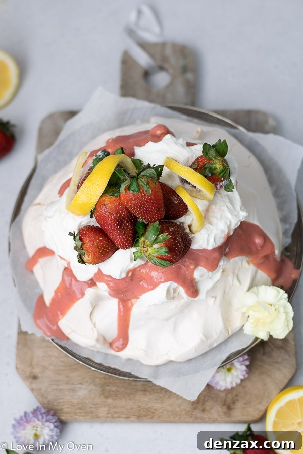 Close-up of a strawberry lemon curd pavlova, showing meringue texture and creamy toppings