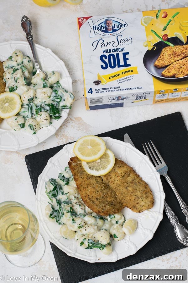 Creamy spinach gnocchi served with pan-seared lemon pepper sole, garnished for a romantic dinner.