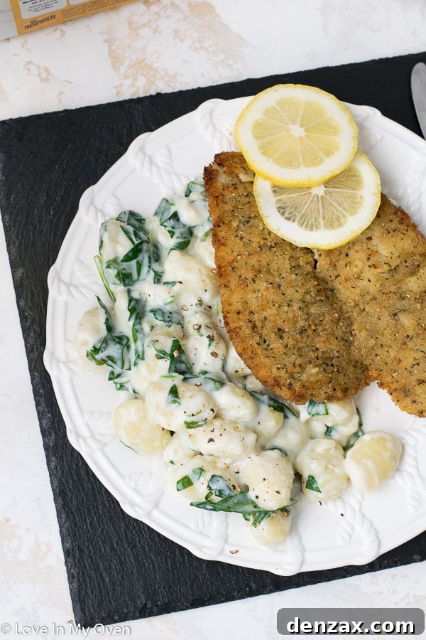 A close-up of creamy spinach gnocchi, showcasing its rich texture and vibrant green spinach.