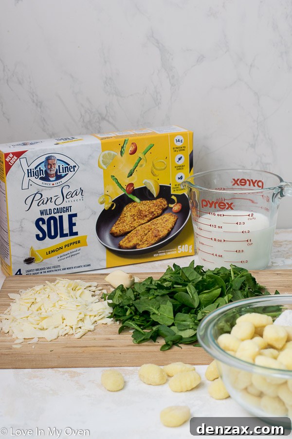 Ingredients for creamy spinach gnocchi laid out on a kitchen counter, highlighting fresh spinach, gnocchi, and cheese.