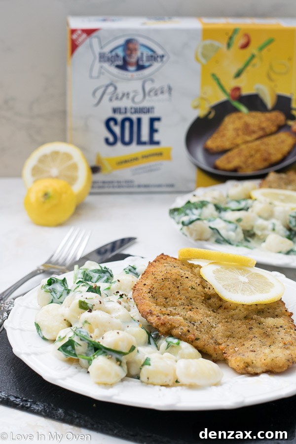 A close-up of a single plate with creamy spinach gnocchi and pan-seared sole, ready to be enjoyed.