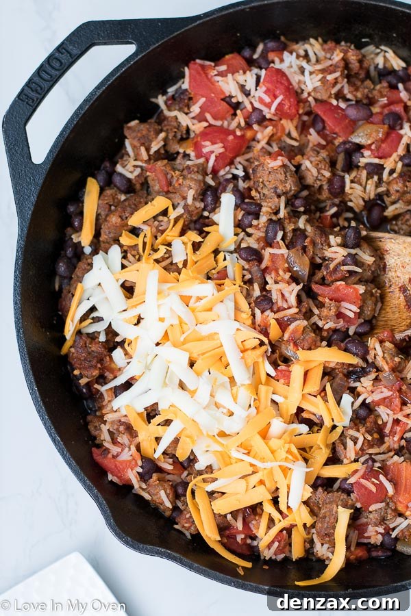 Sautéed onions, garlic, and chorizo cooking in a pan for the pepper filling