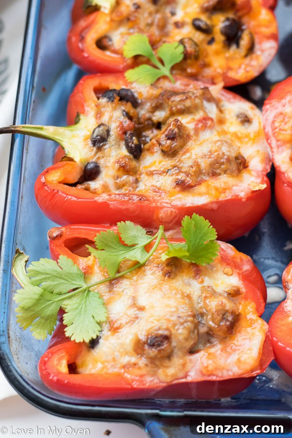 Finished chorizo stuffed peppers garnished with fresh cilantro and avocado slices