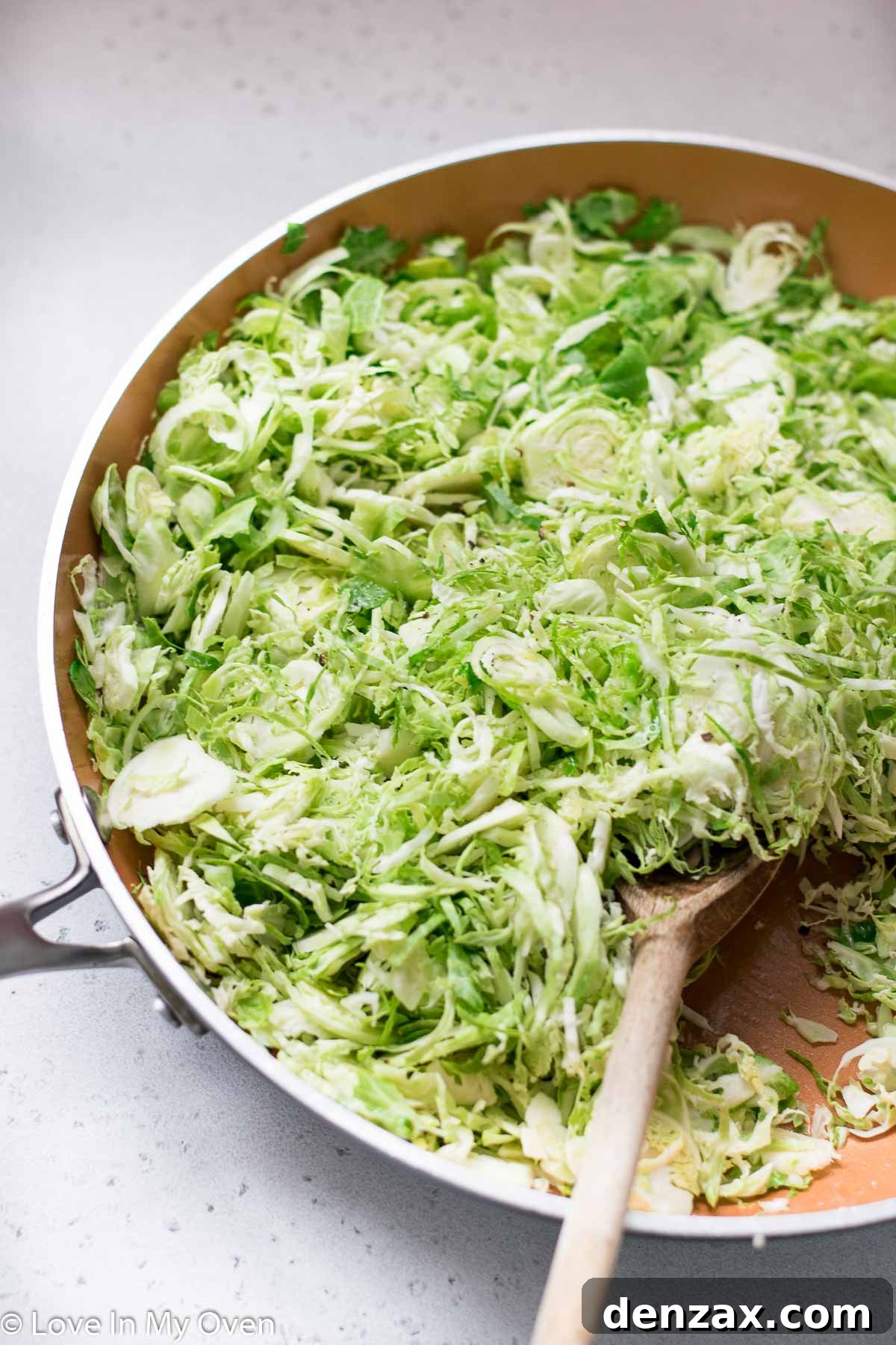 Freshly sautéed shredded Brussels sprouts with lemon juice, ready to serve