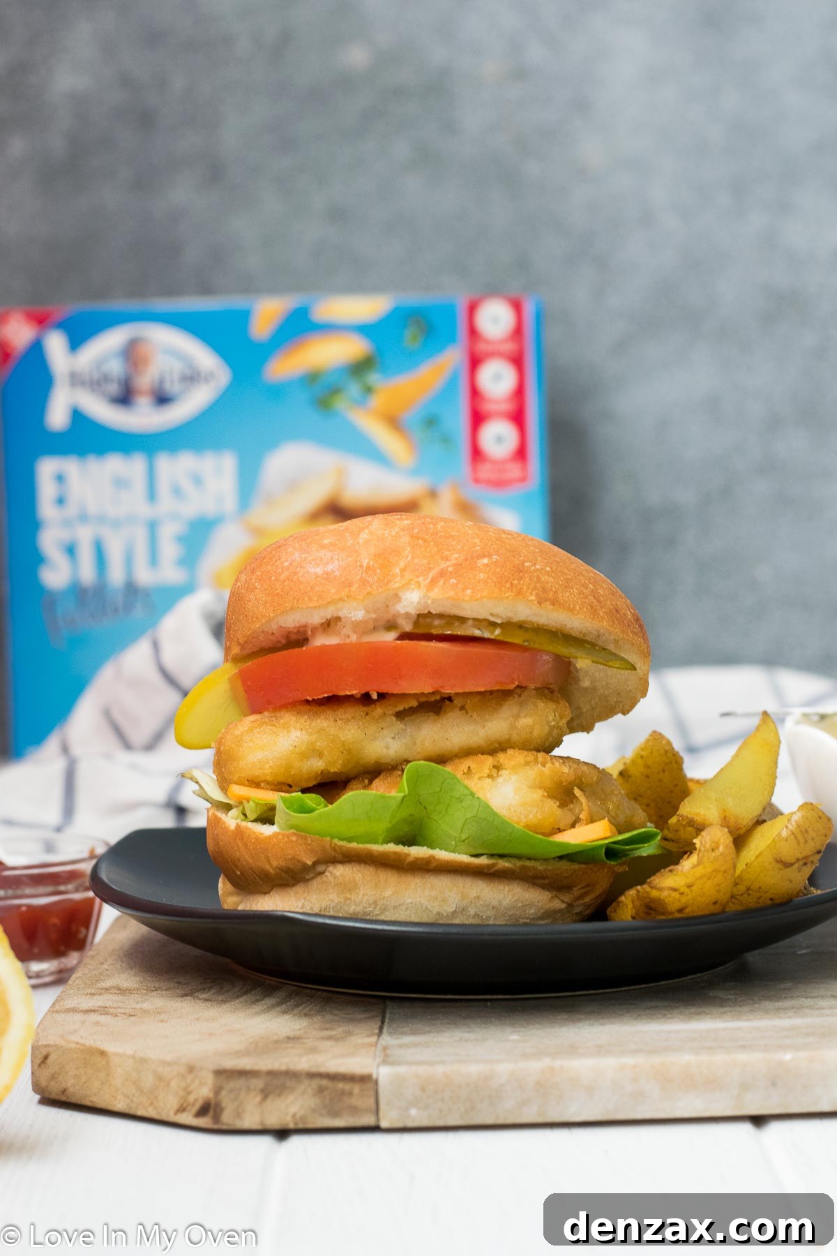 Delicious crispy fish burger served with golden potato wedges and a side of lemon-garlic aioli.