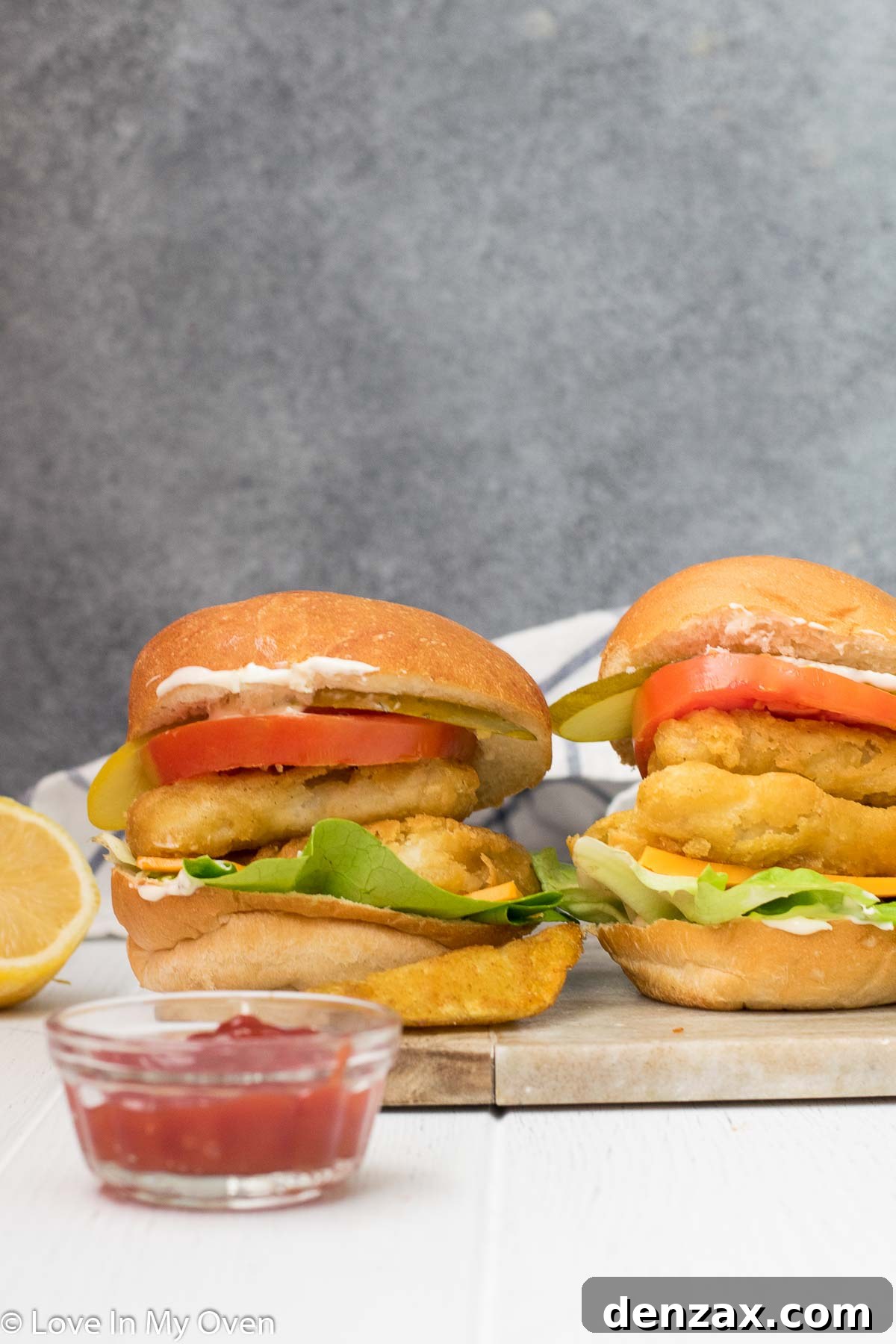 Close-up of a crispy fish burger with fresh toppings, ready to be enjoyed.