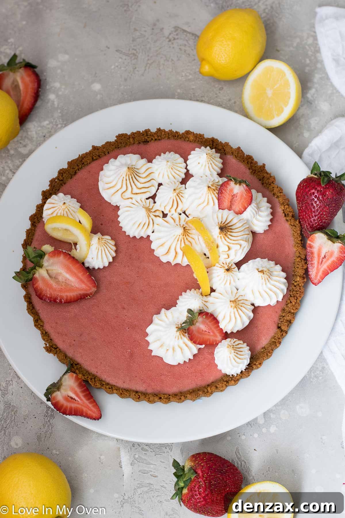 Vibrant Strawberry Lemon Curd Tart with a golden gingersnap crust, garnished with fresh berries.
