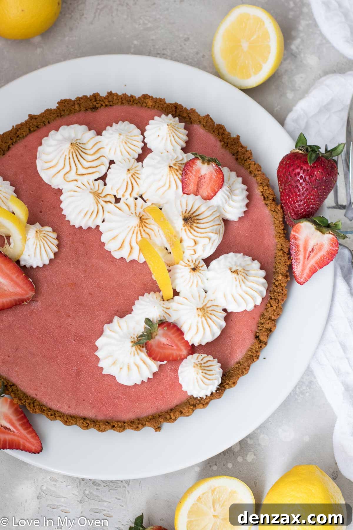 Close-up shot of a slice of strawberry lemon curd tart with a vibrant yellow filling and red strawberry swirls.