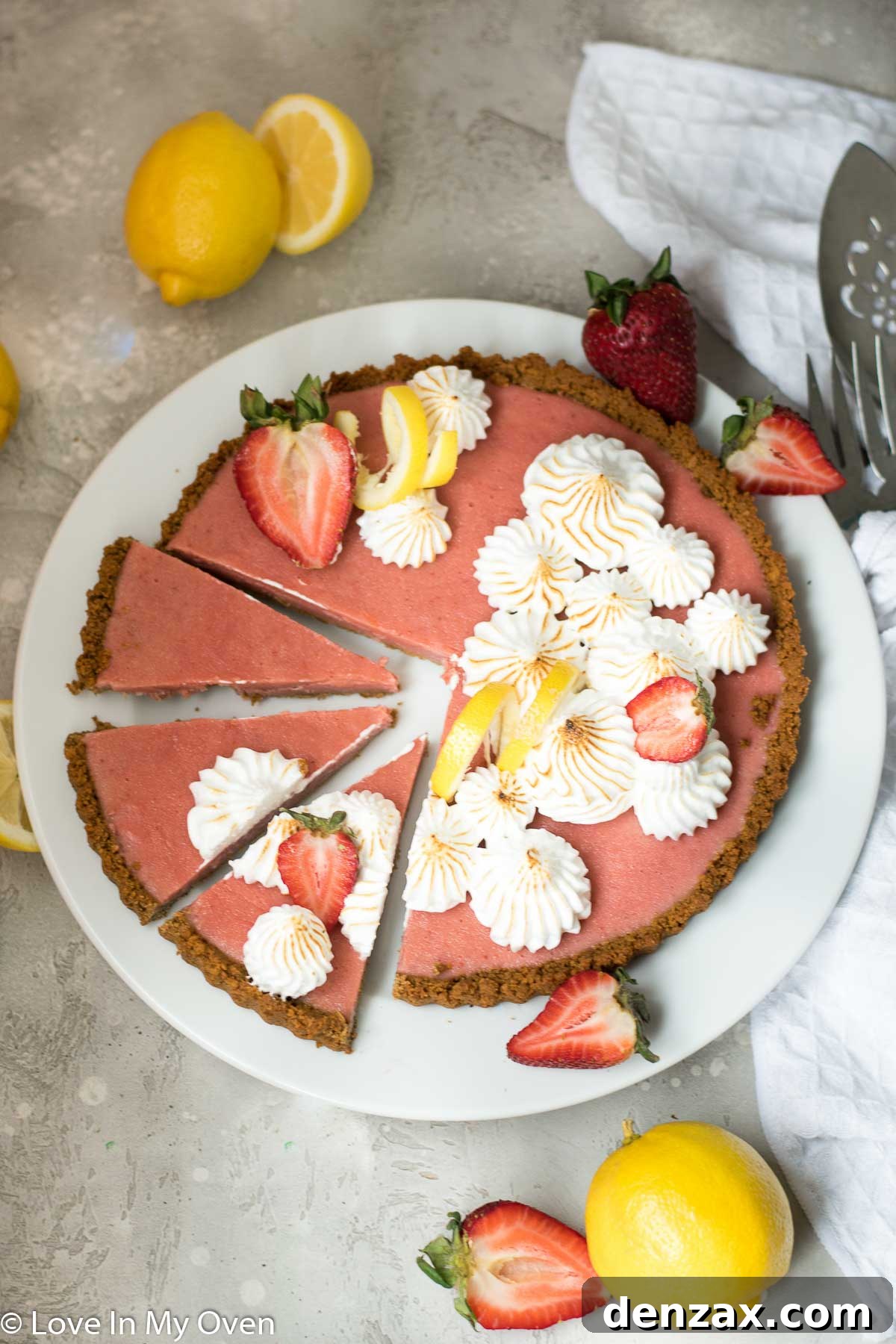 Overhead view of a strawberry lemon curd tart, showcasing the toasted meringue peaks.