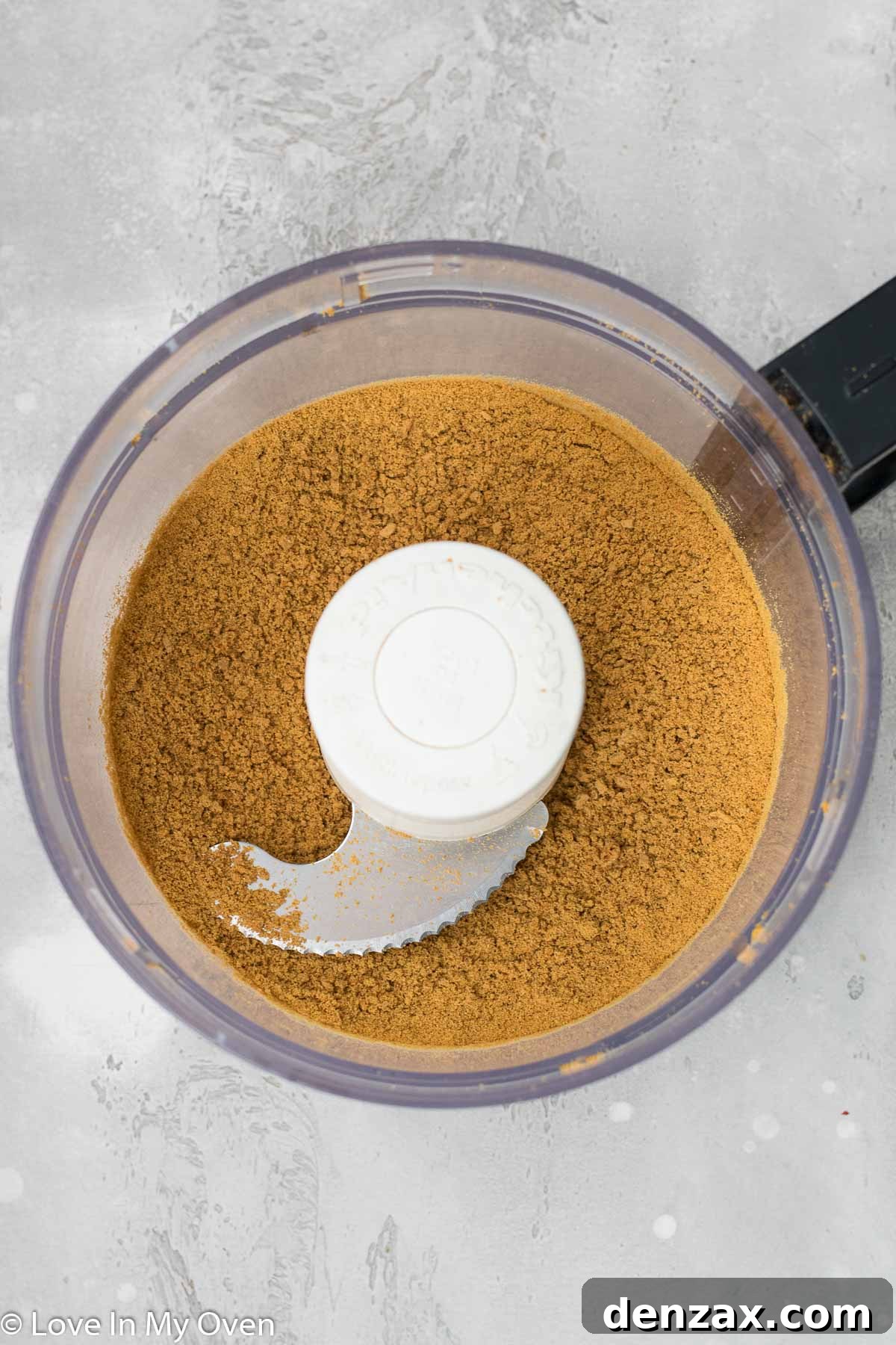 Crushed gingersnap cookies in a bowl, mixed with melted butter for the tart crust.