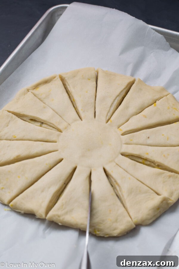 Cutting the layered dough into strips to form the points of the star bread.