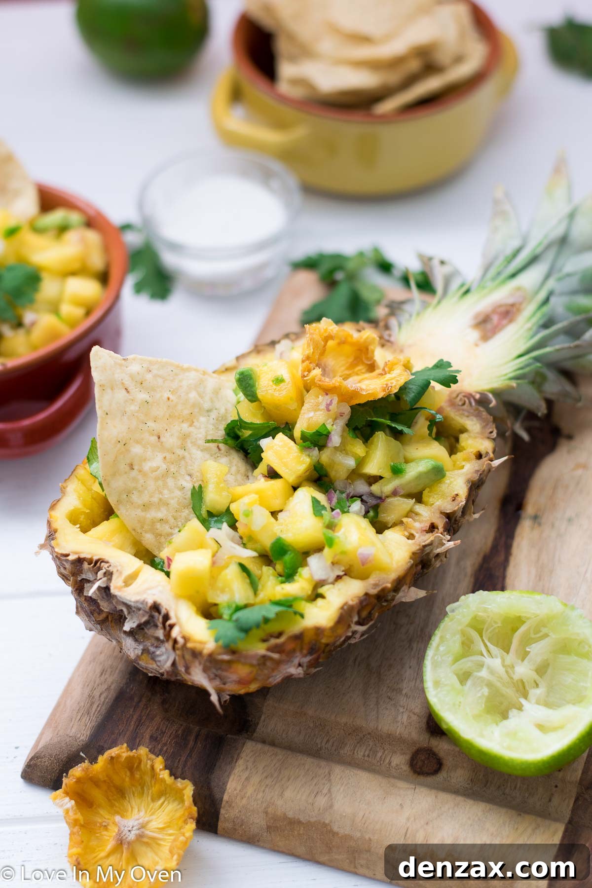 A bowl of pineapple avocado salsa with a spoon, ready for serving
