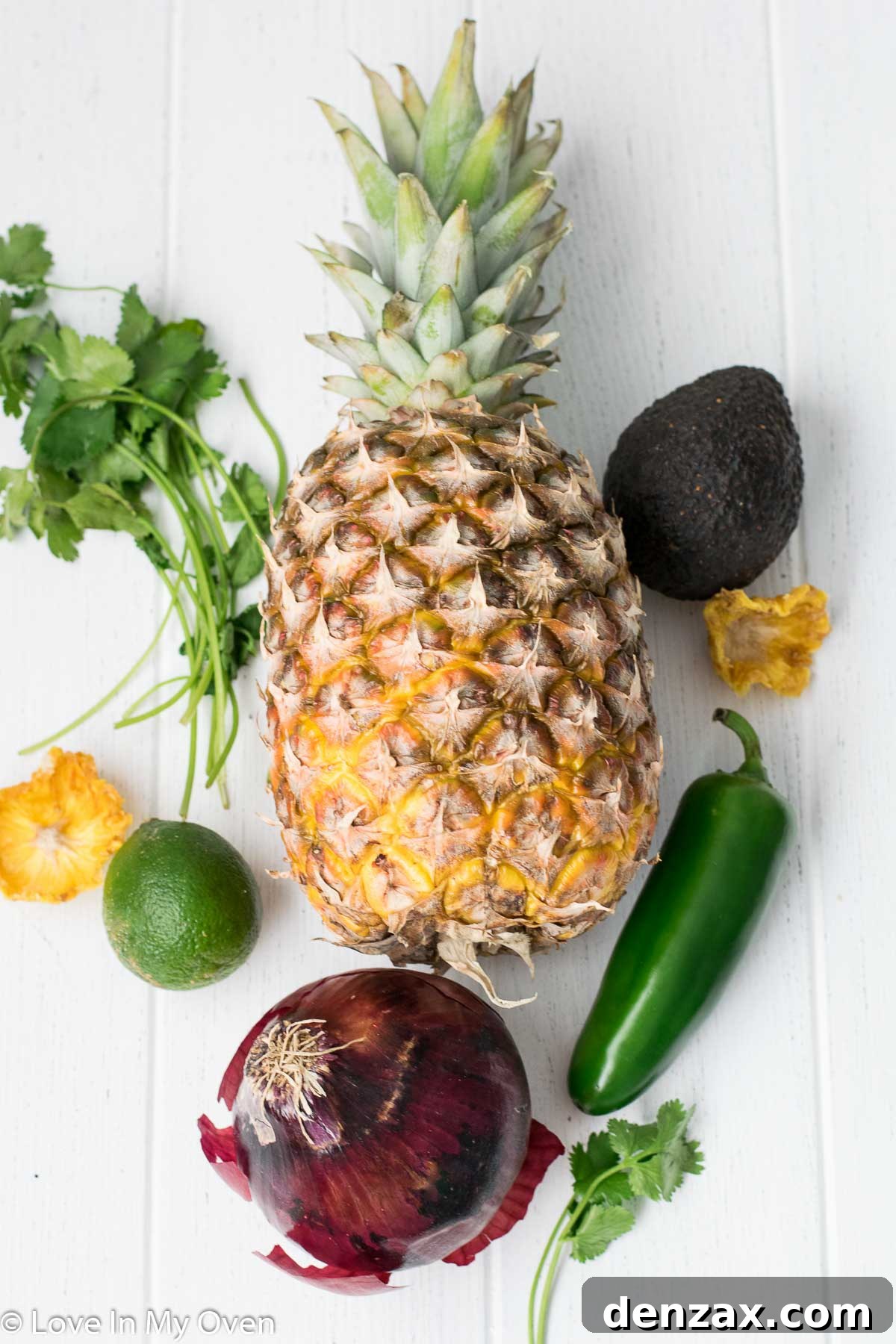 Ingredients for pineapple avocado salsa laid out on a cutting board